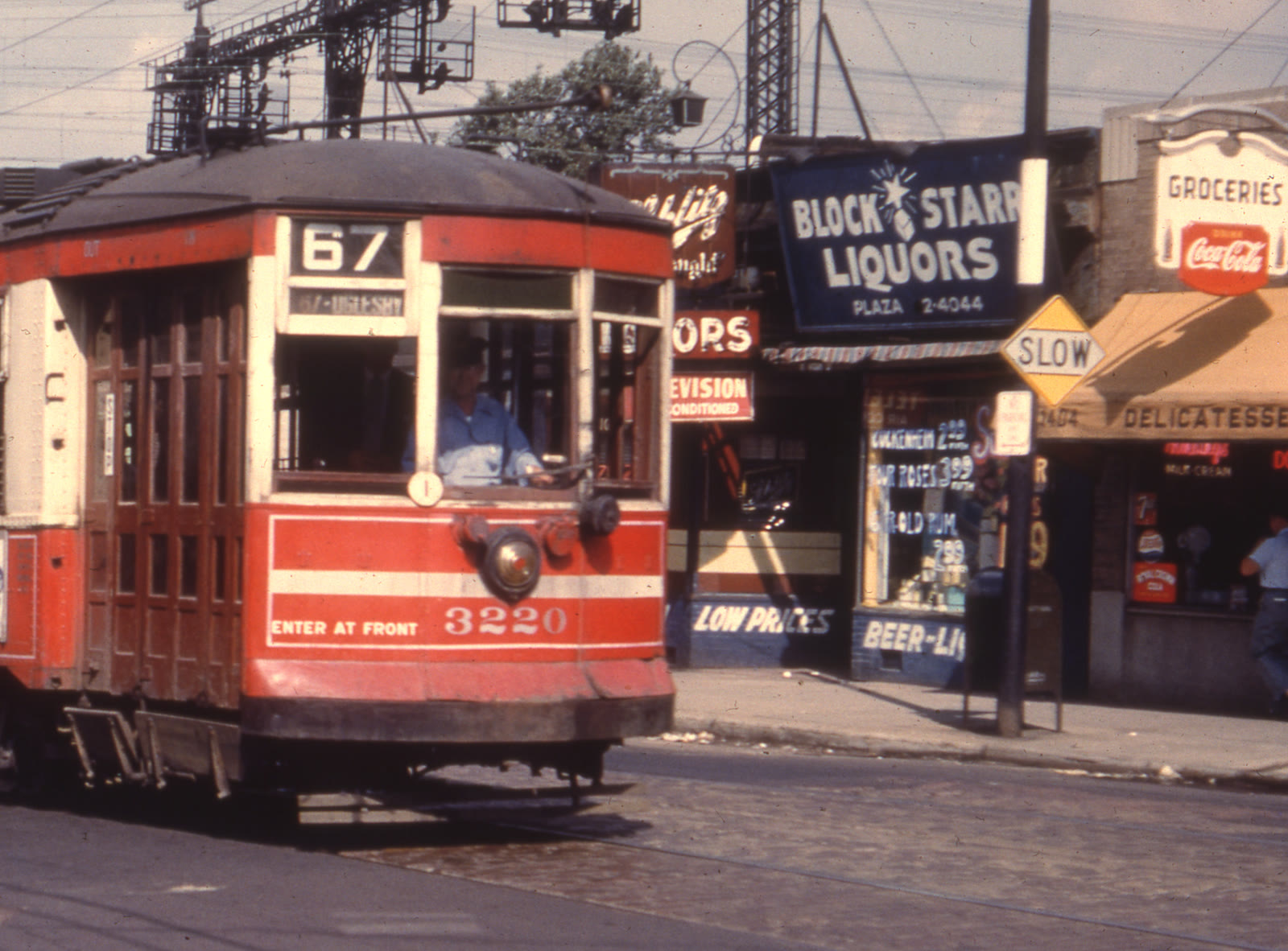 Block-Starr Liquors on East 67th Street in Chicago, its sign showing a star between BLOCK and STARR, with a 67 streetcar passing