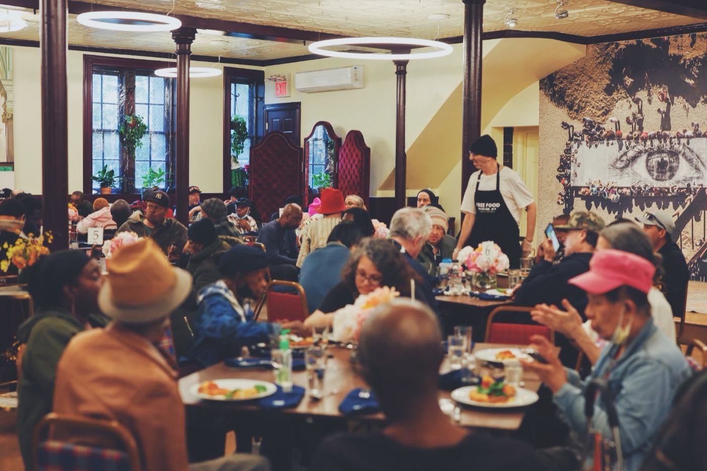 A crowded dining hall at one of Unconditional Freedom's free community dinners